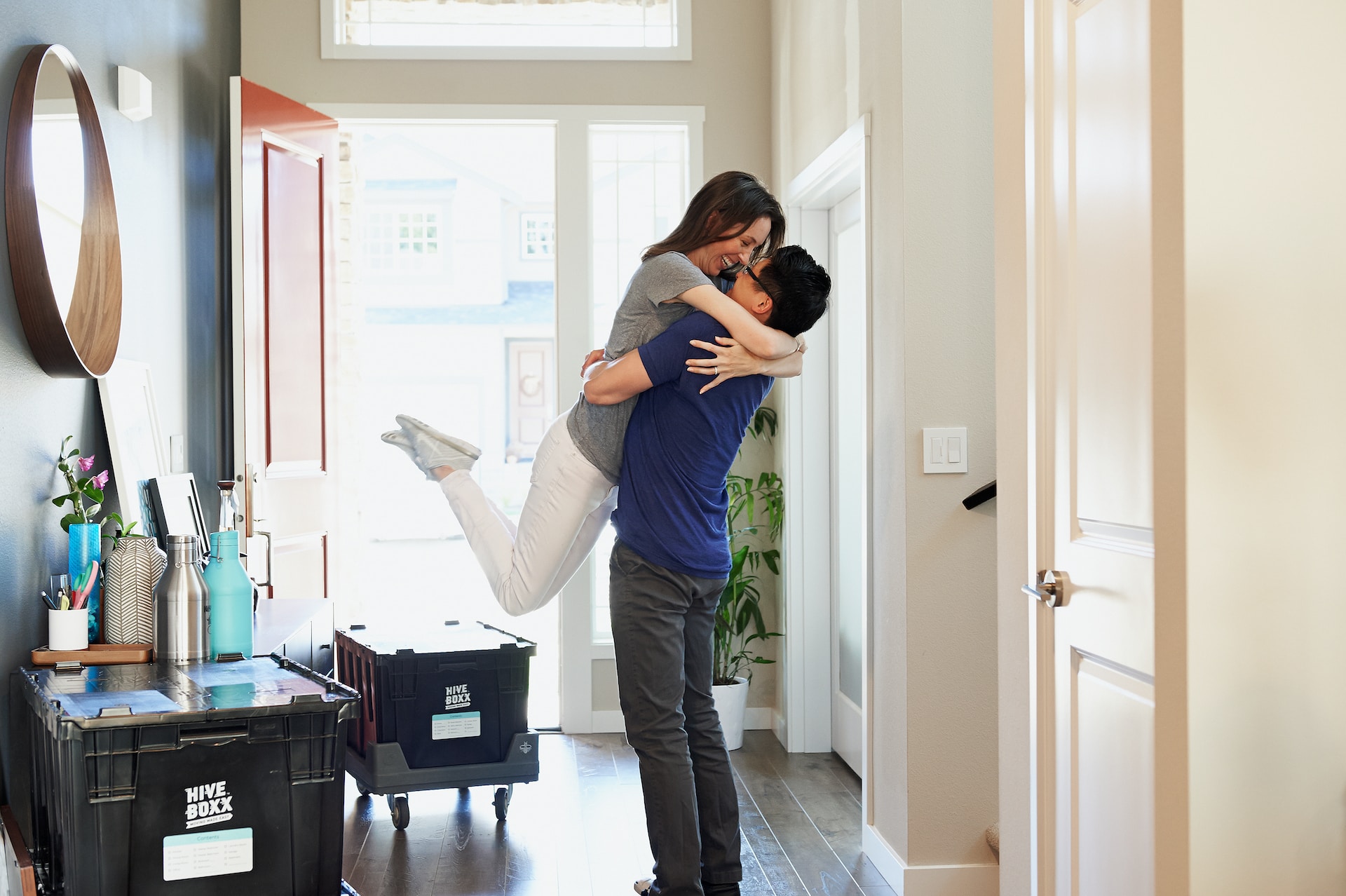 A happy couple hagging in their new home.
