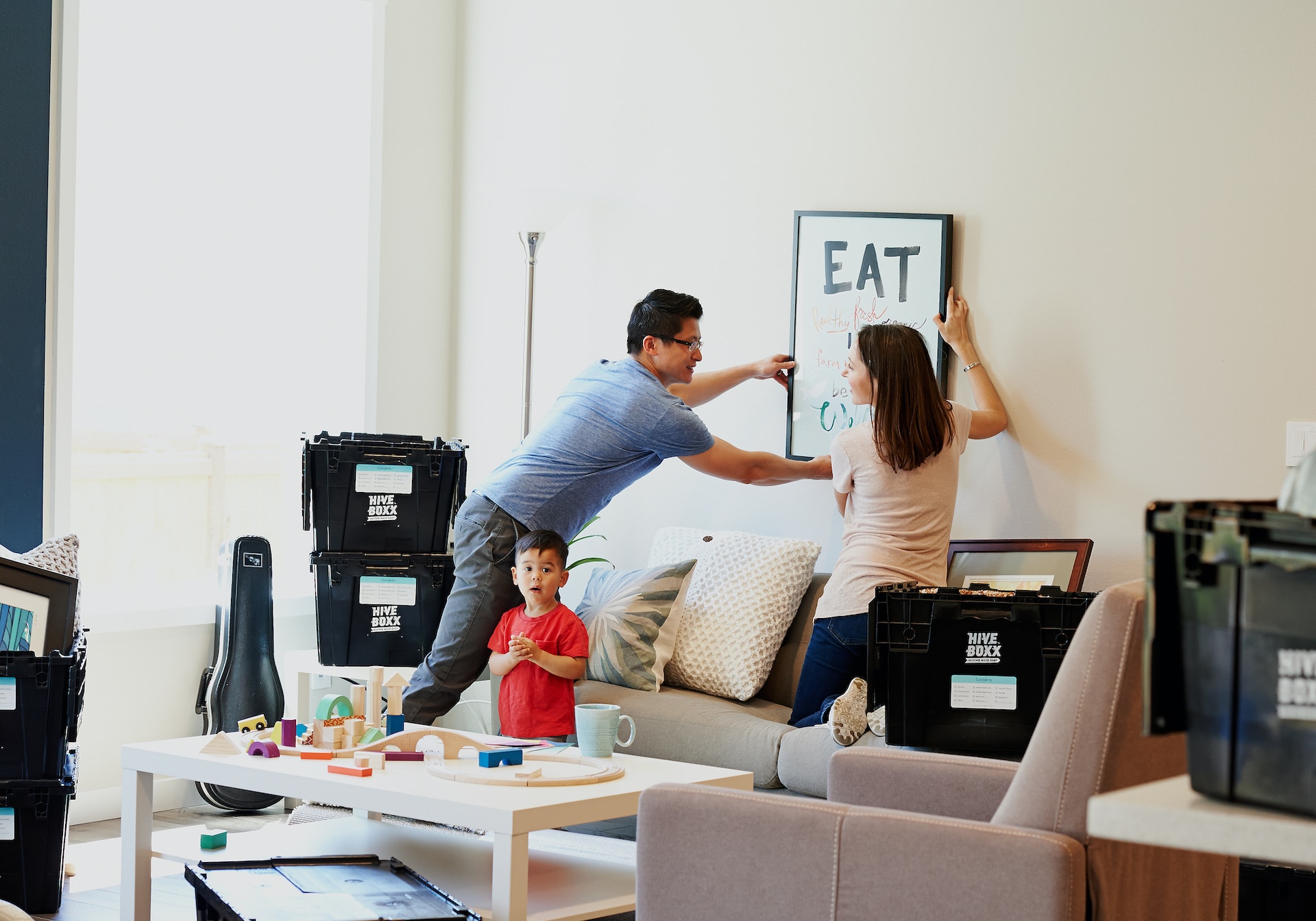 A happy satisfied family arranging their new house.